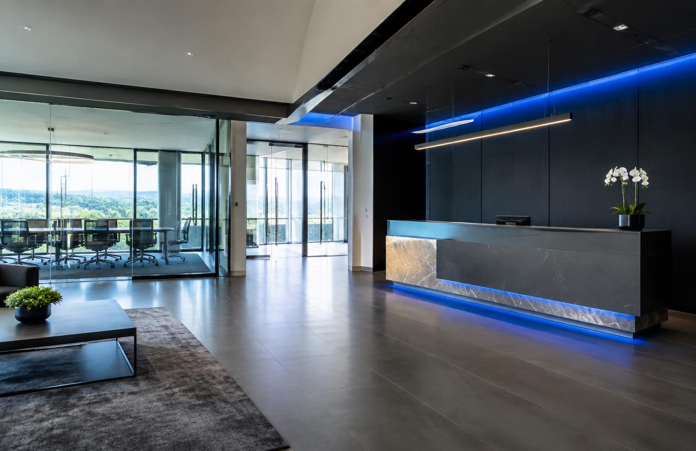Modern professional office reception area with glass walls and dark interior design elements.
